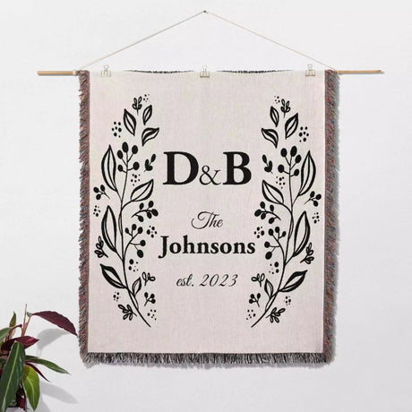 Personalized gift for couple unique cotton anniversary gift woven blanket hanging on a wall on a white background.