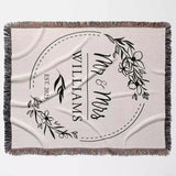 Personalized blanket with 'Mr & Mrs' and 'Williams' text, floral design, and year flat lay on a light background