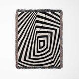 Psychedelic abstract art woven blanket throw tapestry with a geometric pattern full view on a light gray background.