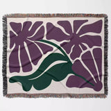 Decorative purple Matisse flowers woven throw blanket with purple floral design on a beige background