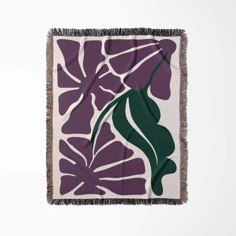 Decorative purple Matisse flowers woven throw blanket with purple leaf pattern on a beige background