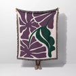 Decorative purple Matisse flowers woven throw blanket with purple and green floral pattern on a white background