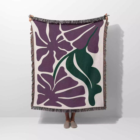 Decorative purple Matisse flowers woven throw blanket with purple and green floral pattern on a white background