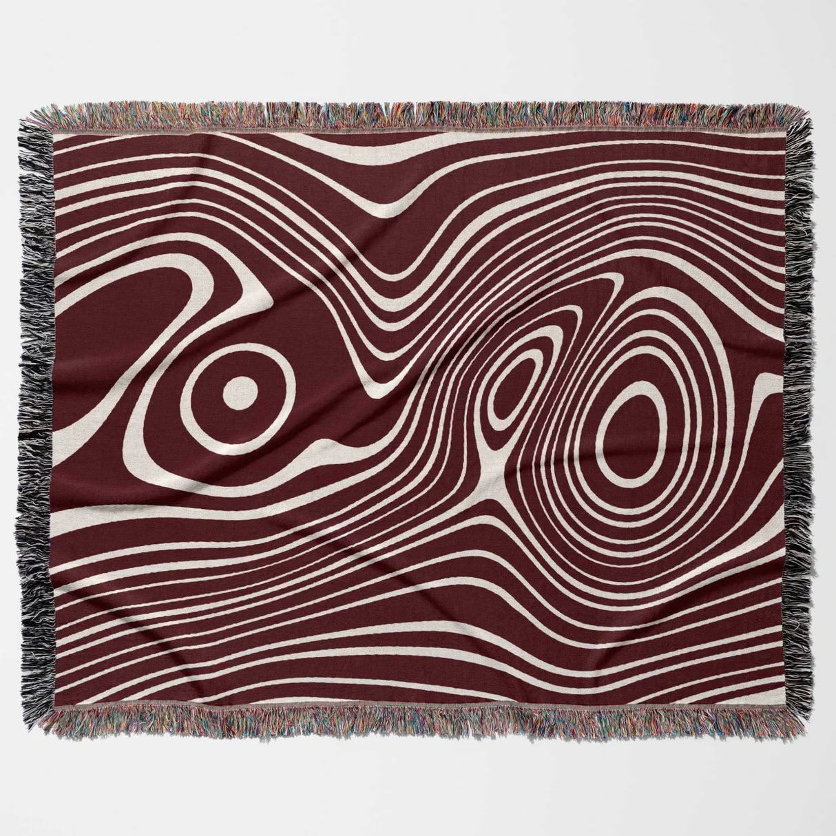 Red abstract woven throw blanket with wavy pattern on a plain background