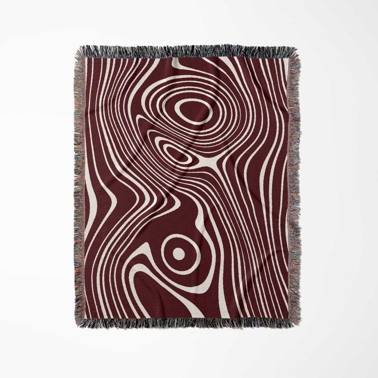 Red abstract woven throw blanket with a swirling pattern on a white background