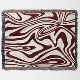 Red marble woven throw blanket for couch with an abstract pattern on a white background