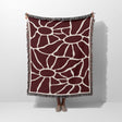 Red Matisse tapestry throw blanket for couch and chair hold by a person on a white background