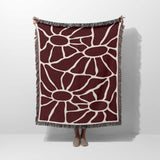 Red Matisse tapestry throw blanket for couch and chair hold by a person on a white background