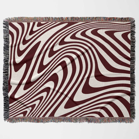 Red modern decorative woven throw blanket with wavy brown and beige pattern on a white background