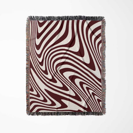 Red modern decorative woven throw blanket with a red and white abstract pattern on a white background