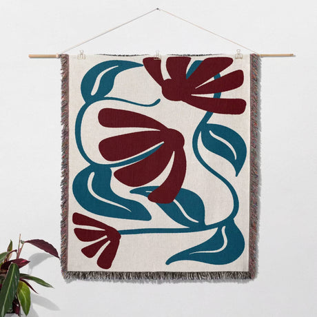 Red and blue Matisse tapestry throw blanket as woven wall art with abstract floral design in red and blue on a white background