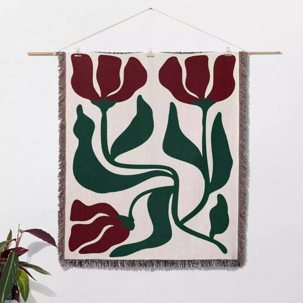 Red and green Matisse flower woven throw blanket woven wall art with red and green tulip design on a white background
