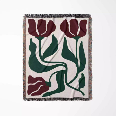 Red and green Matisse flower woven throw blanket floral patterned throw blanket with red tulips and green leaves on a white background
