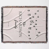 Romantic anniversary custom name blanket flat lay with 'Richardson Family' text and decorative elements on a light background