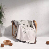 Romantic anniversary custom name blanket with text draped over a chair against a light background