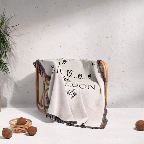 Romantic anniversary custom name blanket with text draped over a chair against a light background