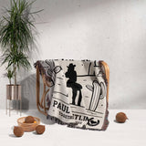Romantic cowboy and cowgirl cotton anniversary gift – woven throw blanket with custom names design draped over a chair, with a plant and decor items in the background.