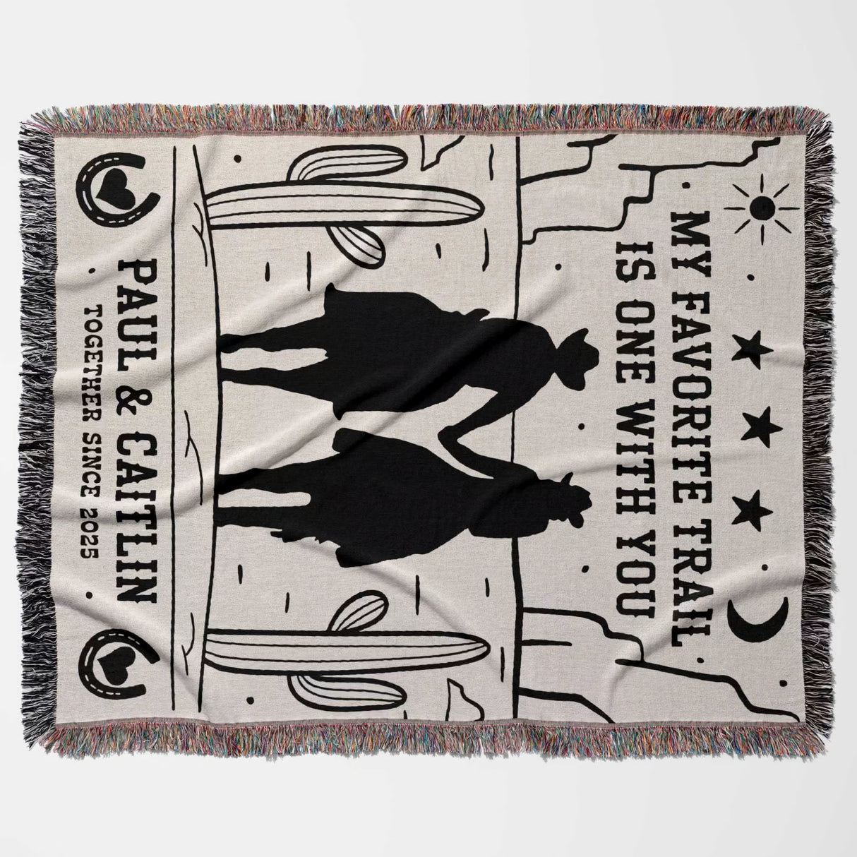 Romantic cowboy and cowgirl cotton anniversary gift – woven throw blanket flat lay with silhouettes of a couple and text on a white background