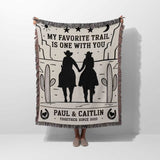 Romantic cowboy and cowgirl cotton anniversary gift – woven throw blanket with cowboy silhouette design and personalized text on a white background