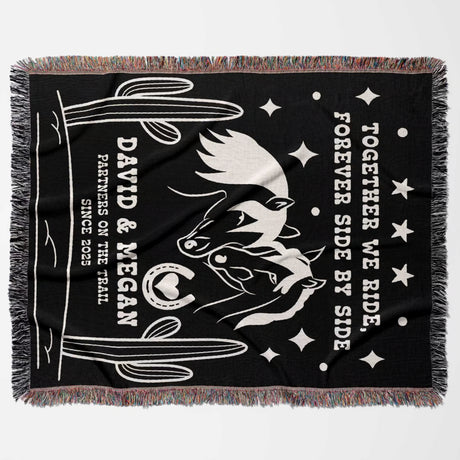Romantic western 2nd anniversary gift - woven throw blanket flat lay with white horse design, text, and fringes on a gray background