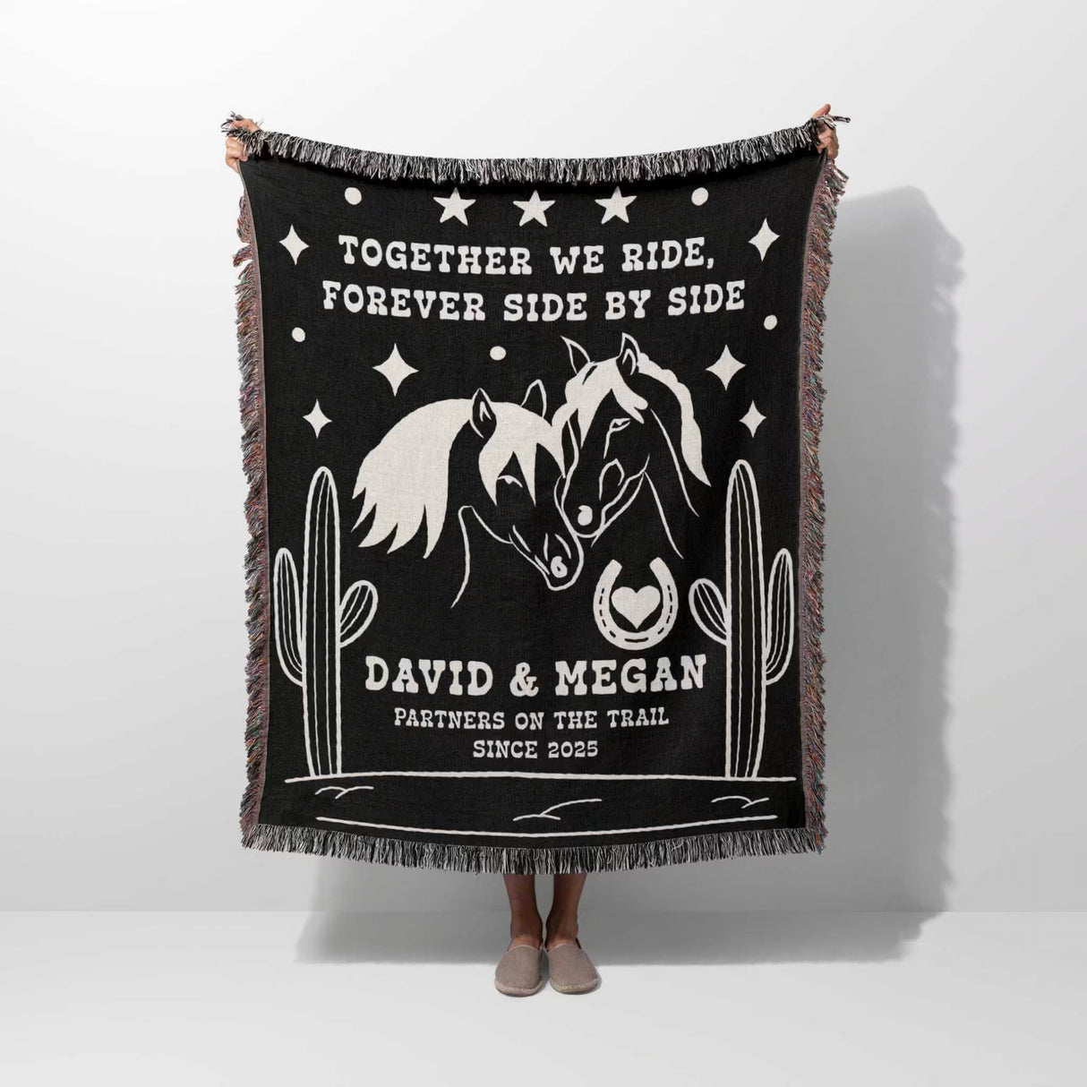 Romantic western 2nd anniversary gift - woven throw blanket with horse design and text held by a person on a white background