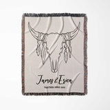 Rustic bull skull cotton anniversary gift woven throw blanket full view with bull skull design and personalized text on a beige background