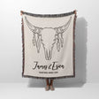 Rustic bull skull cotton anniversary gift woven throw blanket held by a person with bull skull design and personalized text on a white background