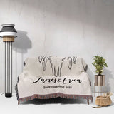 Rustic bull skull cotton anniversary gift woven throw blanket with 'James & Erica Together Since 2023' text on a couch against a white wall.