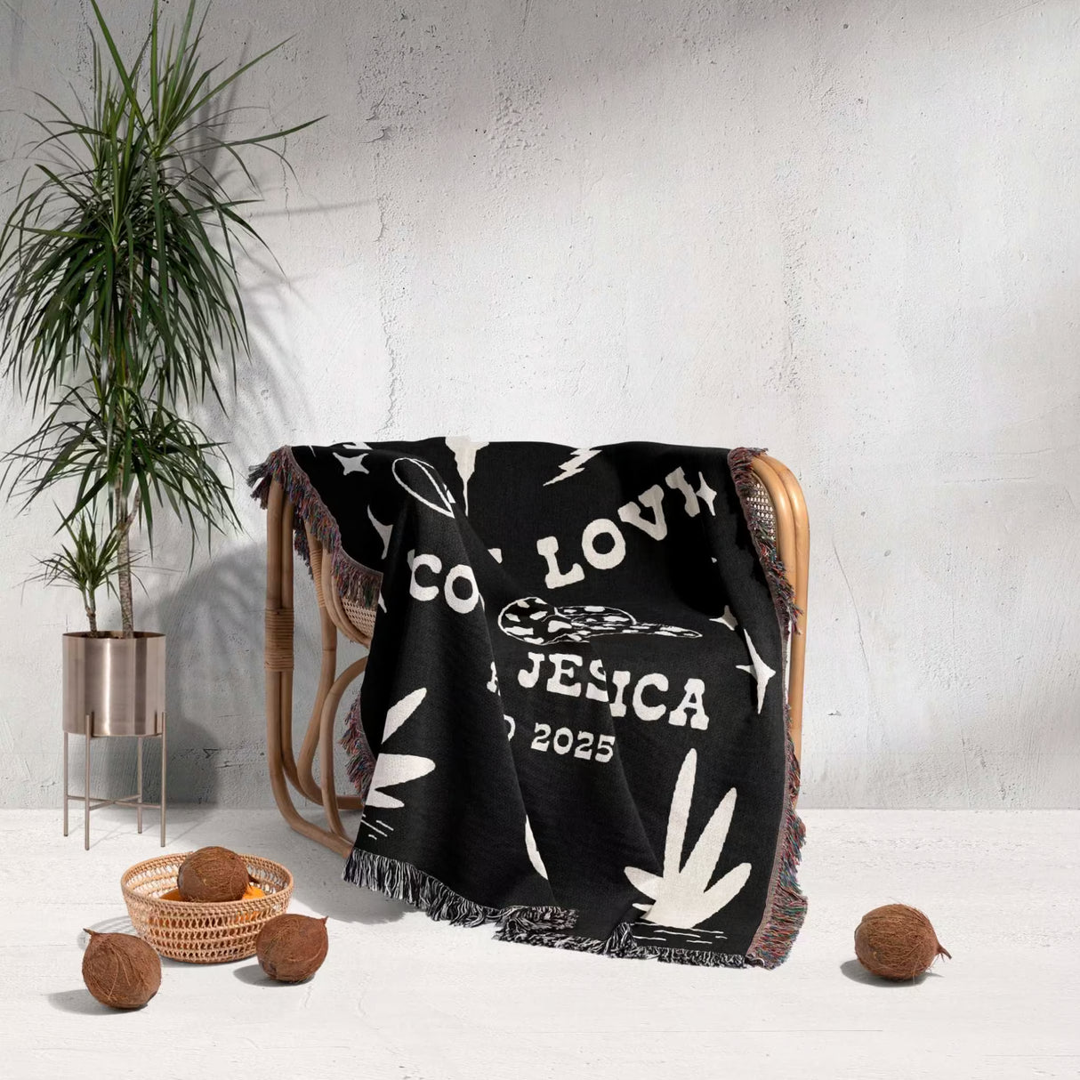 Rustic western 2nd anniversary gift woven throw blanket with white designs draped over a chair in a room with a plant and decorative items.