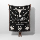 Rustic western 2nd anniversary gift woven throw blanket with white designs and text, featuring a longhorn skull and cowboy hats, on a white background.