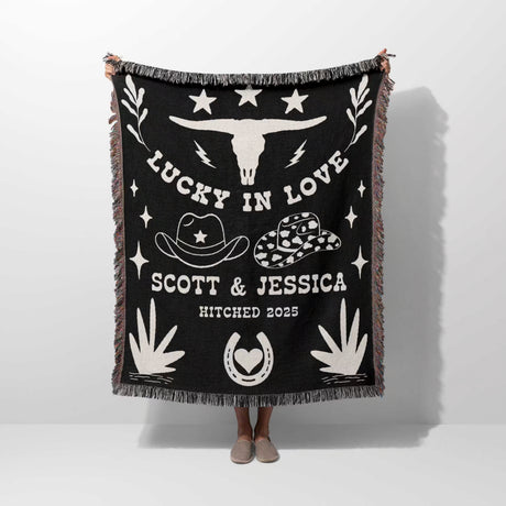 Rustic western 2nd anniversary gift woven throw blanket with white designs and text, featuring a longhorn skull and cowboy hats, on a white background.