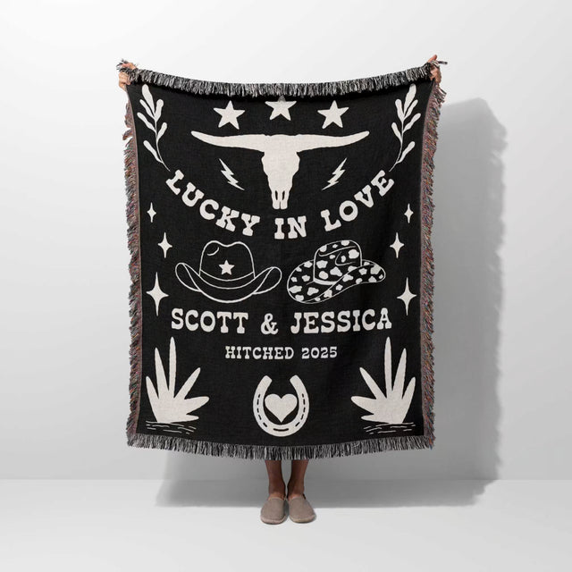 Rustic western 2nd anniversary gift woven throw blanket with white designs and text, featuring a longhorn skull and cowboy hats, on a white background.
