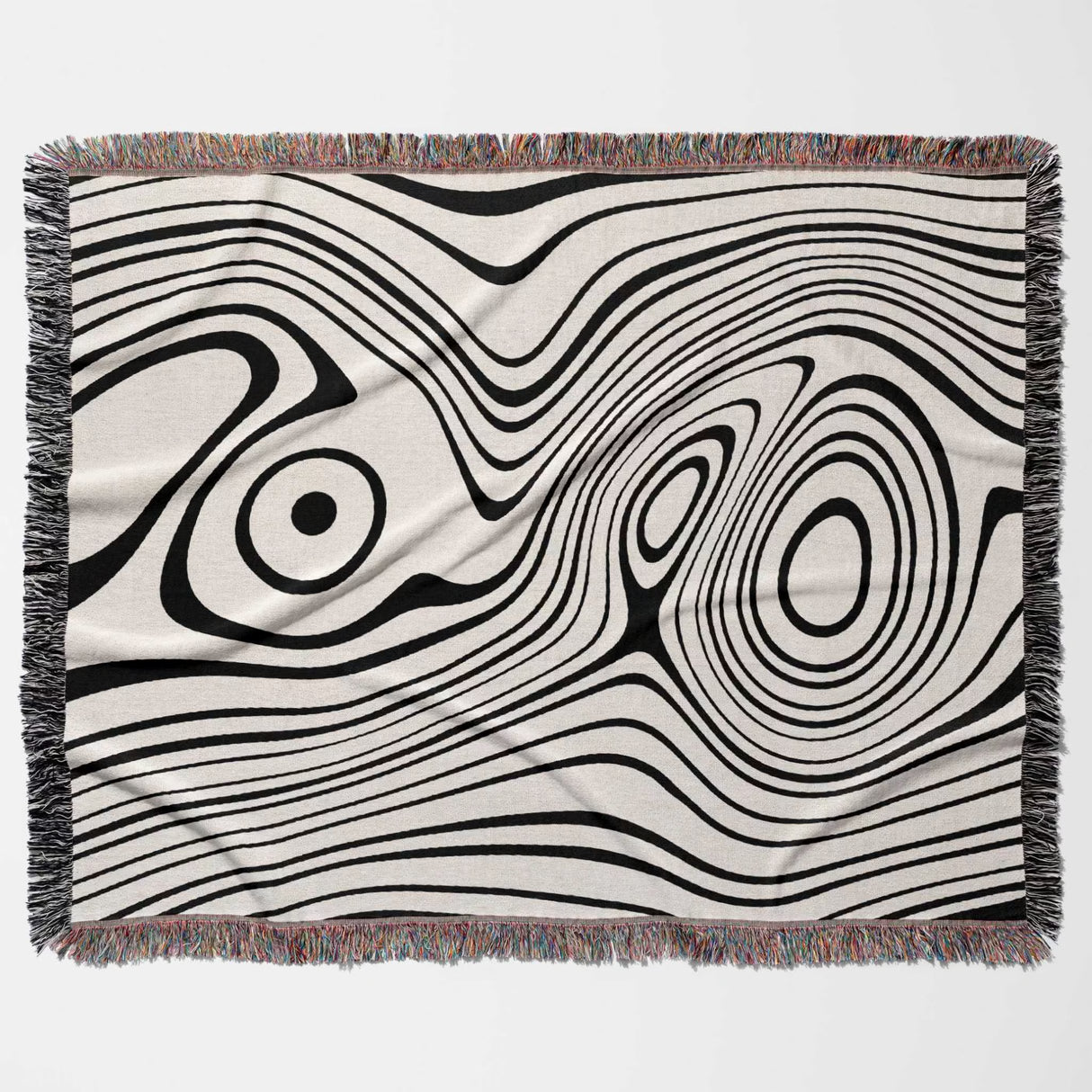 Simple black and white modern couch woven throw blanket with black and white abstract pattern on a beige background