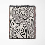 Simple black and white modern couch woven throw blanket with black and white abstract pattern on a white background