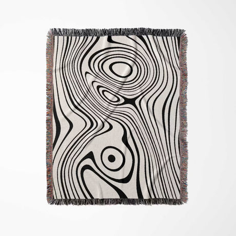 Simple black and white modern couch woven throw blanket with black and white abstract pattern on a white background