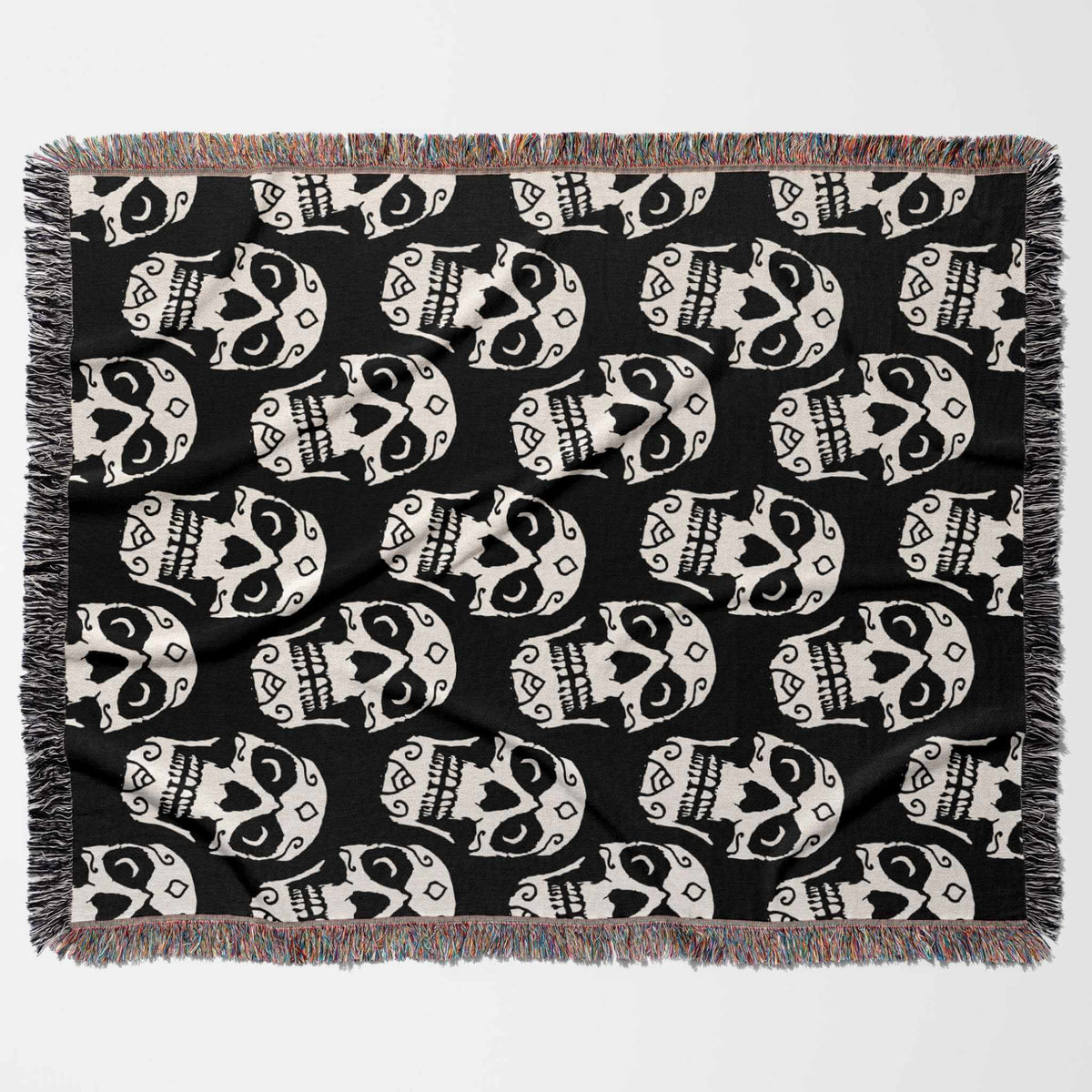 Black blanket with white skull pattern on a white background