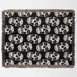 Black blanket with white skull pattern on a white background
