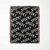 Black blanket with 'Spooky' text pattern on a white background