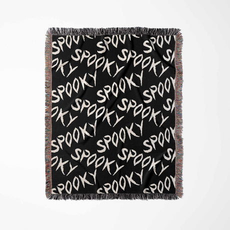 Black blanket with 'Spooky' text pattern on a white background