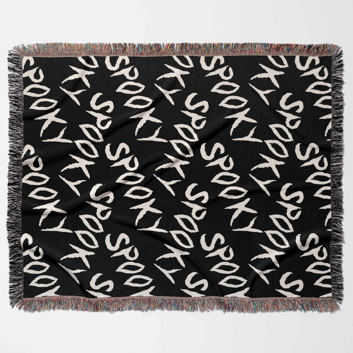Black blanket with 'Spooky' text pattern on a white background