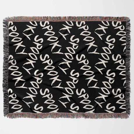 Black blanket with 'Spooky' text pattern on a white background
