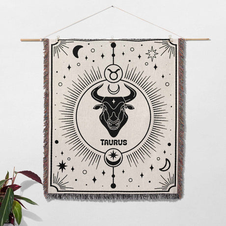 Taurus Zodiac Blanket hung as wall art decor, featuring the intricate woven design with the Taurus symbol. Ideal for home decoration and as a unique birthday gift idea for women and men who love astrology.