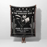 Two horses 2nd anniversary gift woven throw blanket with white text and graphics, featuring a horse and cactus design, held by a person.