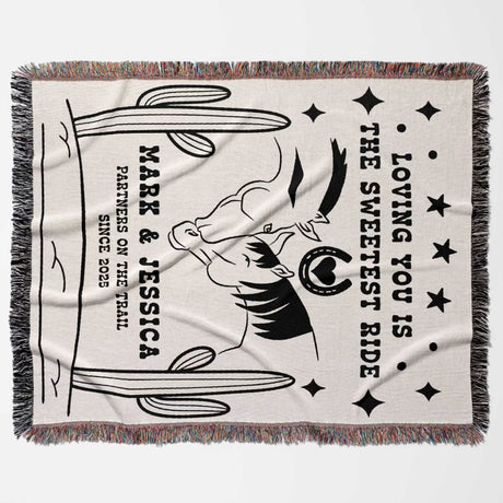 Two horses woven throw blanket cotton anniversary gift flat lay with black and white graphic design featuring text and a horse, on a light background.
