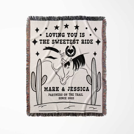 Two horses woven throw blanket cotton anniversary gift full view with horses and cactus design, text 'Loving you is the sweetest ride' and personalized names.
