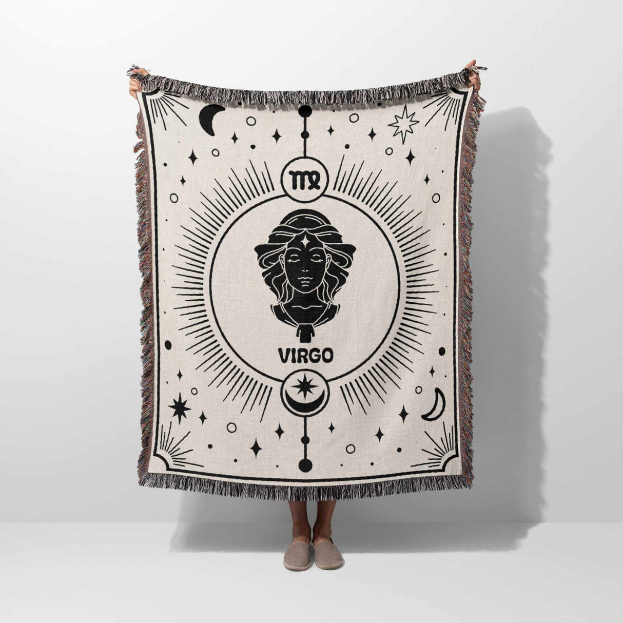 Person holding the Virgo Zodiac Blanket vertically, displaying its detailed Virgo design and celestial motifs. The black and white woven tapestry is ideal for astrology enthusiasts and home decor, combining style and comfort.