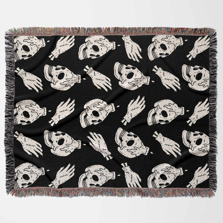 Black blanket with white skull and hand pattern on a white background