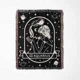 This image displays a vertical flat lay of a Zodiac Sign Blanket, highlighting the Aquarius star sign. The intricate black-and-white design features an Aquarius woman and celestial elements, making it ideal for home decor and astrology lovers.