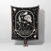 This image features a person holding a Zodiac Sign Blanket vertically, displaying the Aquarius astrological sign. The woven throw tapestry showcases a detailed black-and-white design with celestial and constellation elements, perfect for astrology enthusiasts and home decor.